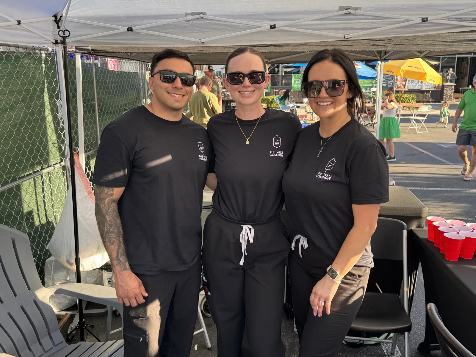 The Well Company team at their branded IV hydration tent during a Temecula community event